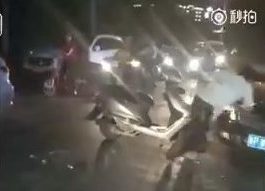  The drunk falls over, crashing into the pavement, when he tries to mount his scooter