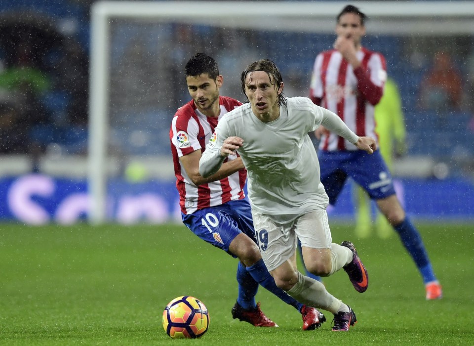  Luka Modric wearing eco-friendly kit during rainy day in Madrid