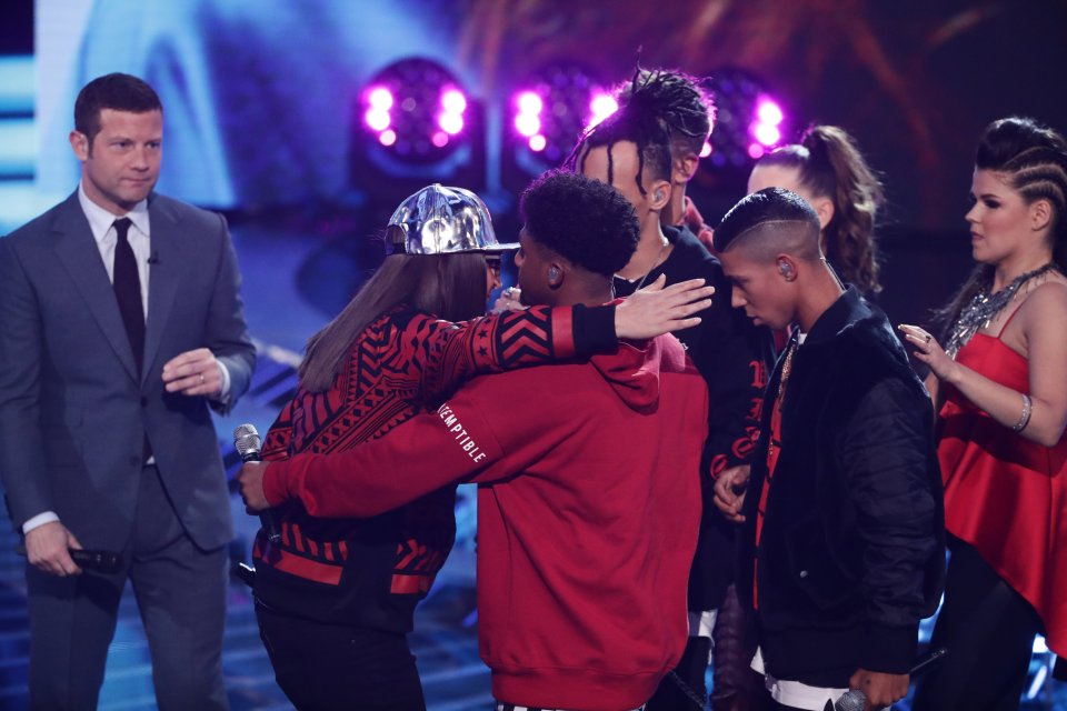  The rapper hugged the boyband goodbye as she departed the competition