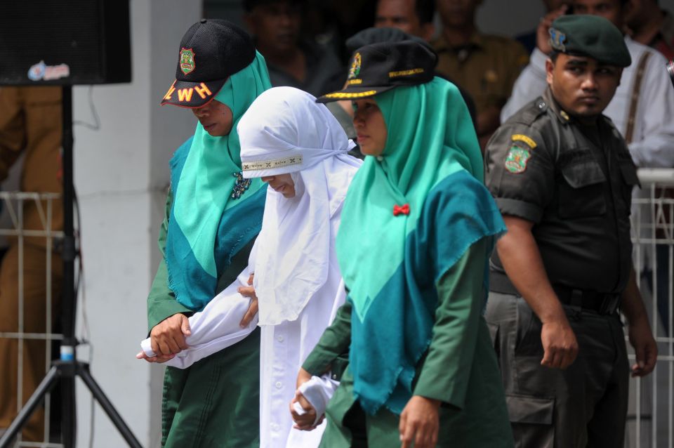  Acehnese sharia policewomen guard the convict