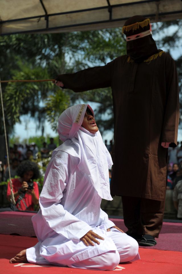  The cane strikes the woman and she screams in pain