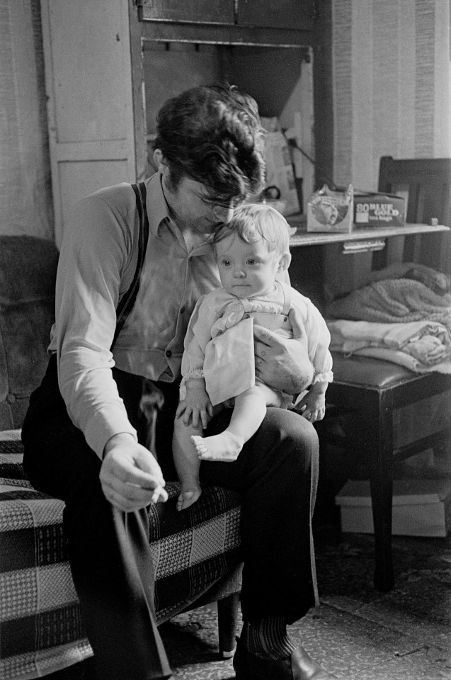  A father and his child sitting in a Maryhill tenement 1971