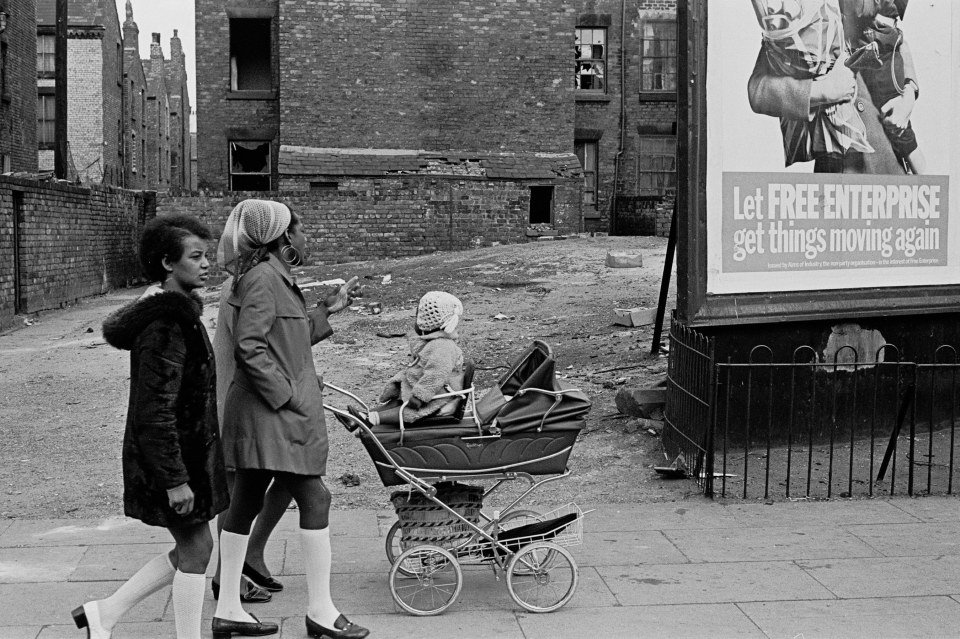  Liverpudlians walking past an election poster, 1969, Liverpool