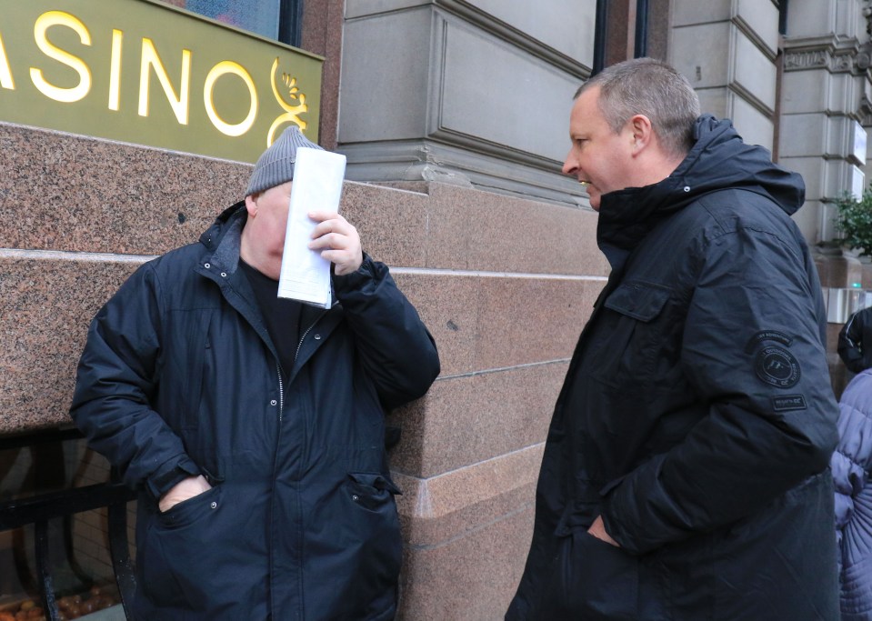  Clarke tries to hide his face when our reporter confronts him