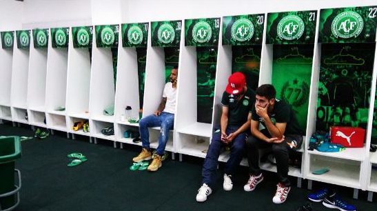  Three Chapecoense players who did not travel with the squad on the ill-fated flight sit in shock in the club's dressing room