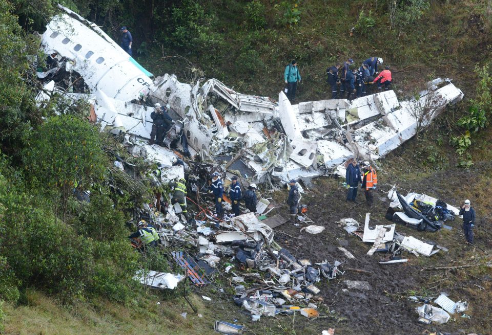  Workers search the wreckage of Flight LMI2933 which came down in Colombia, killing 75