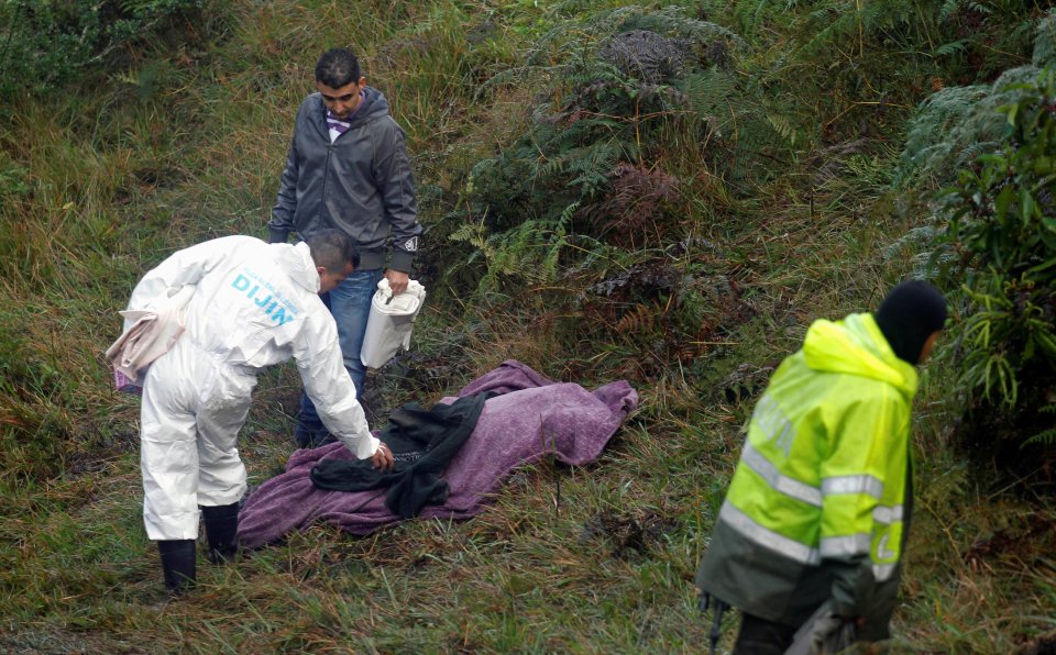  A rescue work checks a body from the jungle crash