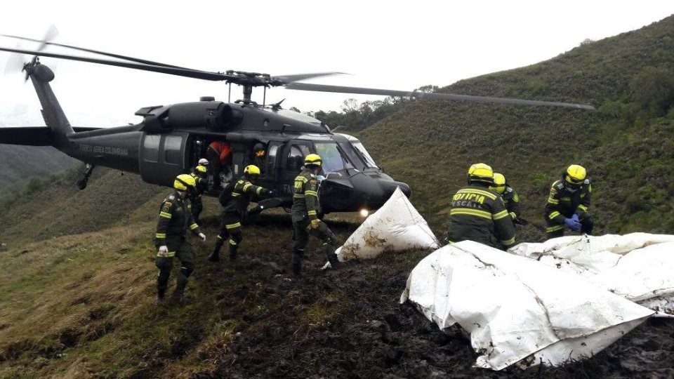  Emergency workers haul body bags onto the rescue helicopter