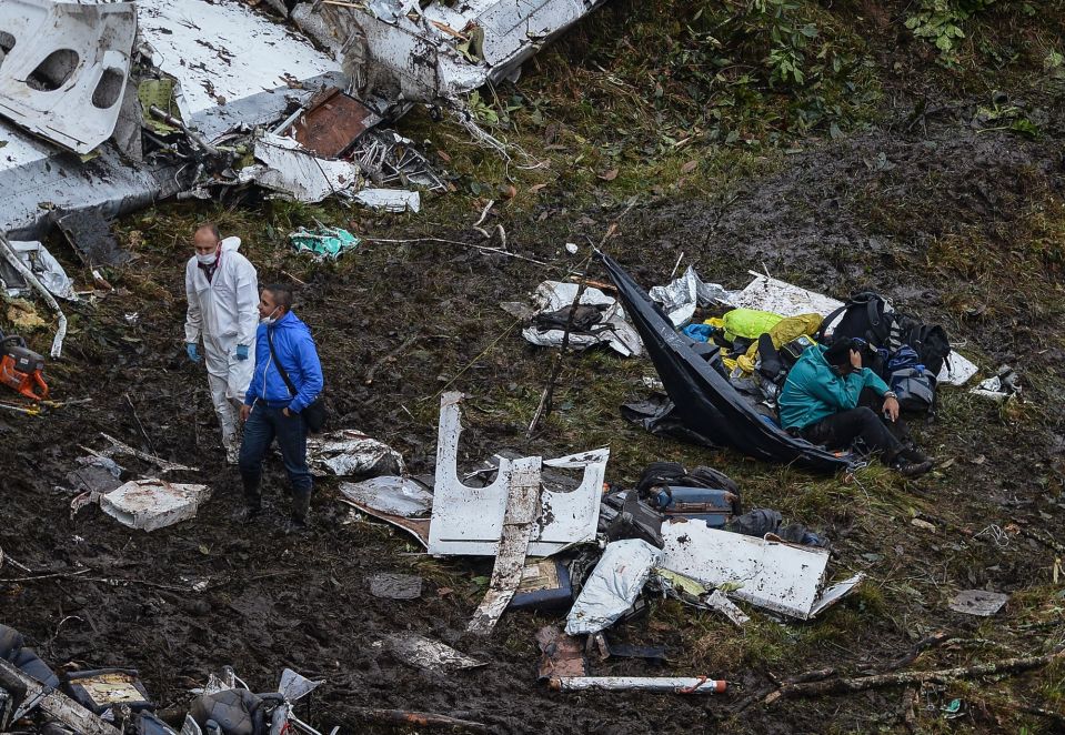  Wreckage is scattered across the crash site as workers try to make sense of the disaster