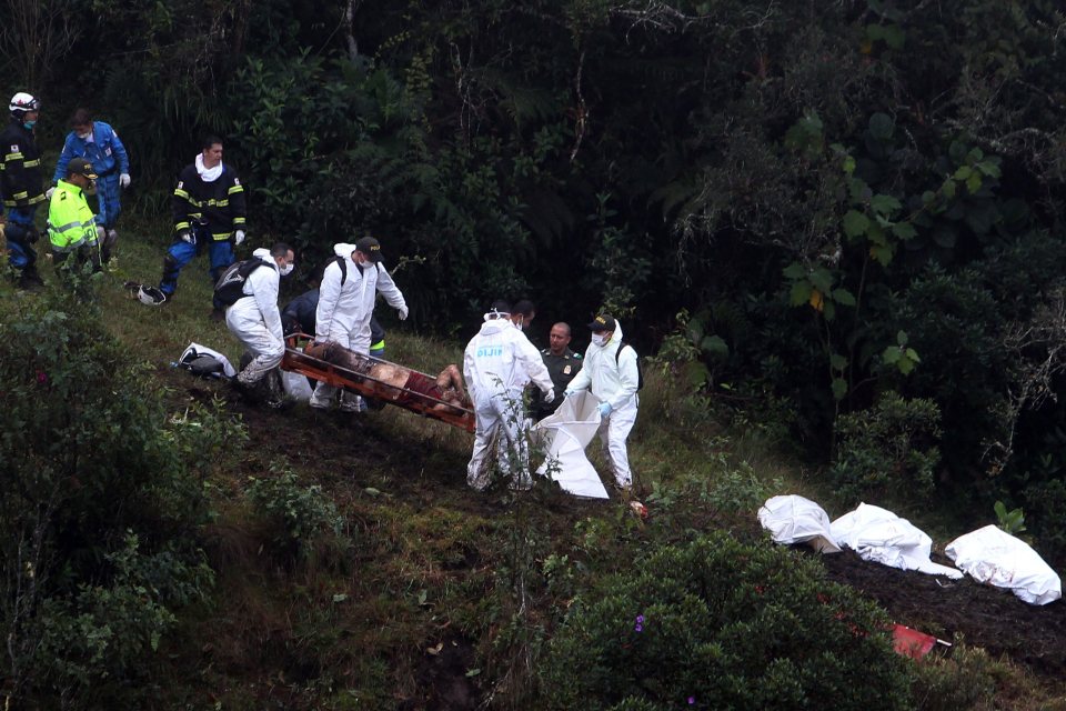  Medics carry one of the injured towards a helicopter