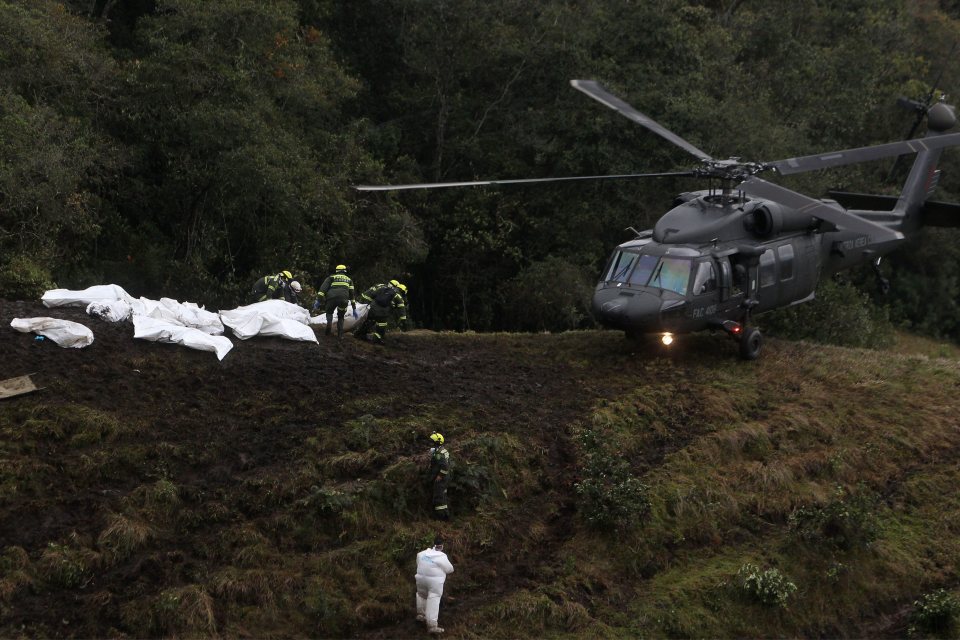  A number of bags filled with the tragic crash victims are laid out in front of a rescue helicopter