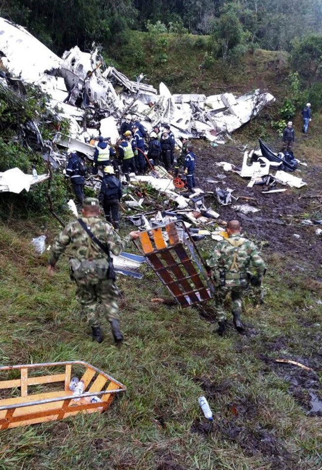  Rescue workers carrying iron stretchers to the scene of the crash