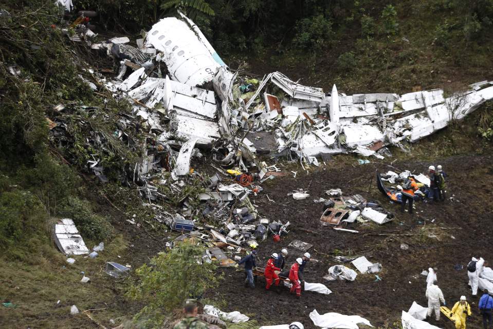  Rescue workers stand at the wreckage site of the horrific crash, where 71 died