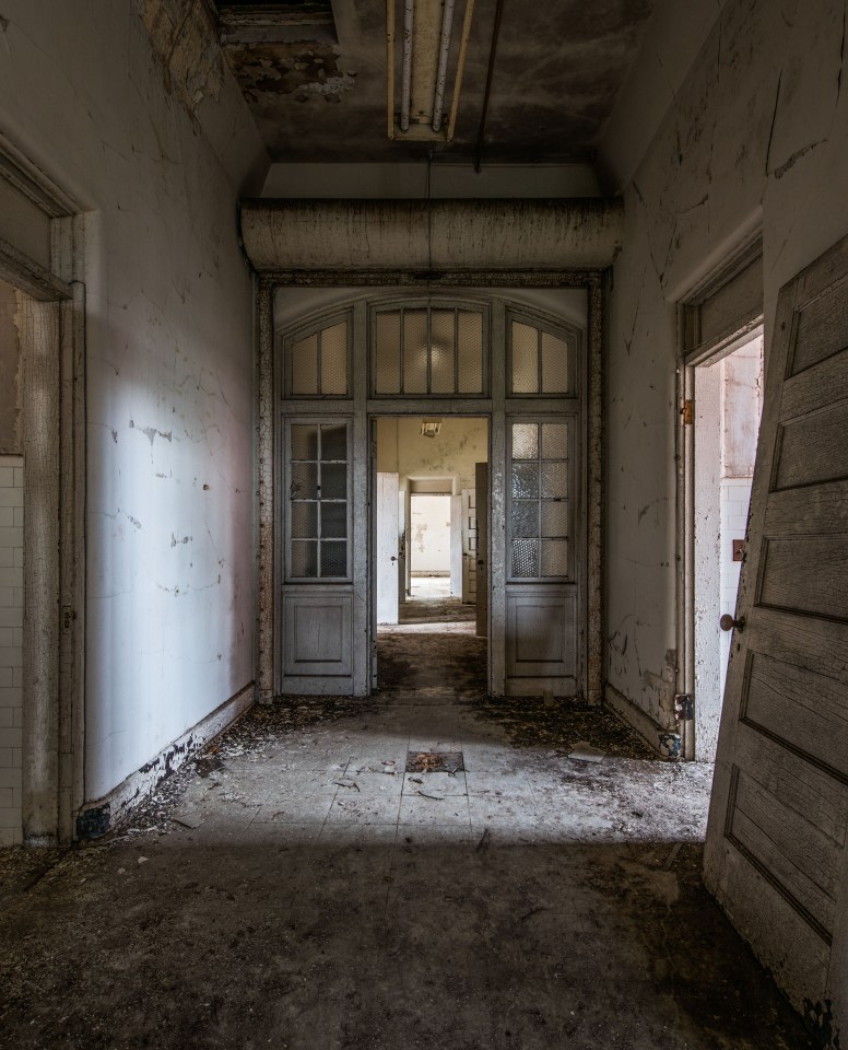  A door is ripped from its hinges on this creepy corridor