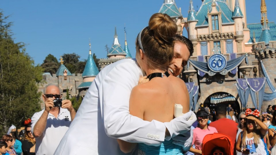  She said yes! Theme park guests look on in glee as Chris hugged his wife-to-be