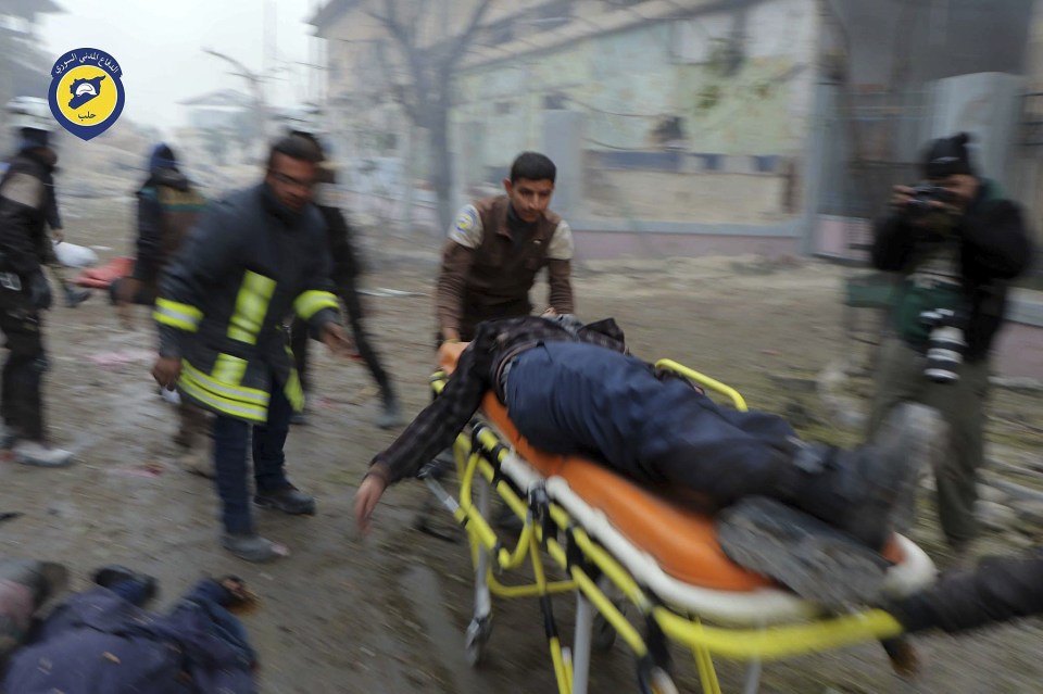  Civil Defence workers carrying a victim on a stretcher after artillery fire struck the Jub al-Quba district in Aleppo earlier today