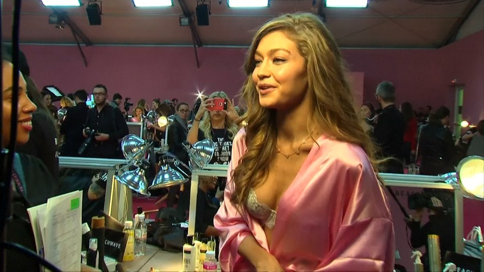  Gigi looked great as she draped her pink silk robe around her shoulders