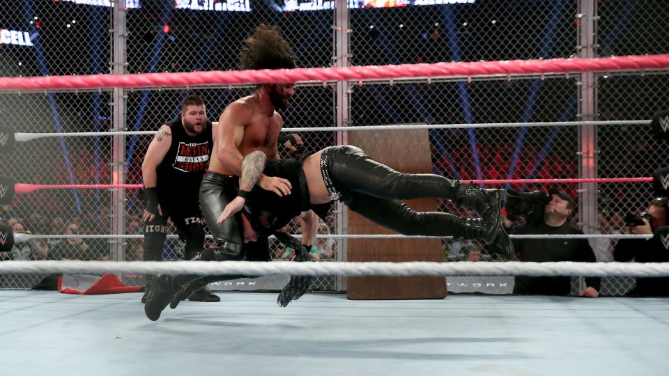  Seth Rollins pedigrees Chris Jericho inside the cage