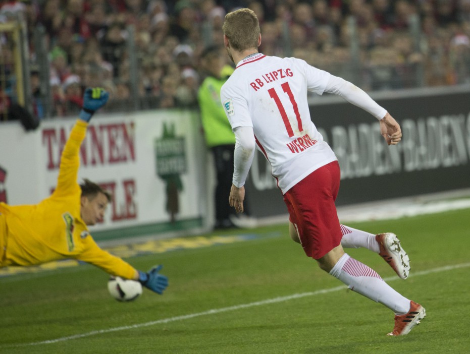  Leipzig's forward Timo Werner scores past Freiburg's goalkeeper as they kept ahead at the top of the league