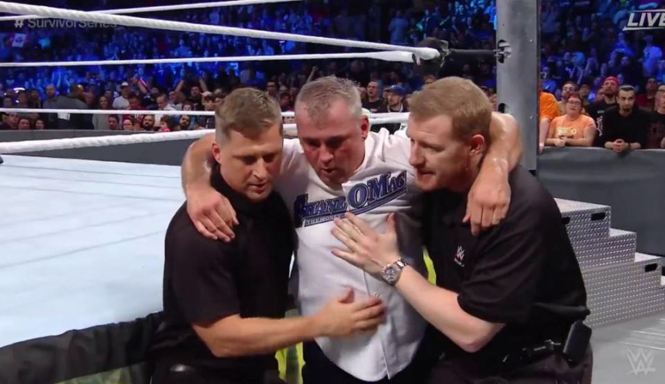  Shane McMahon is helped to be the back by officials after being legitimately knocked out after spot went wrong