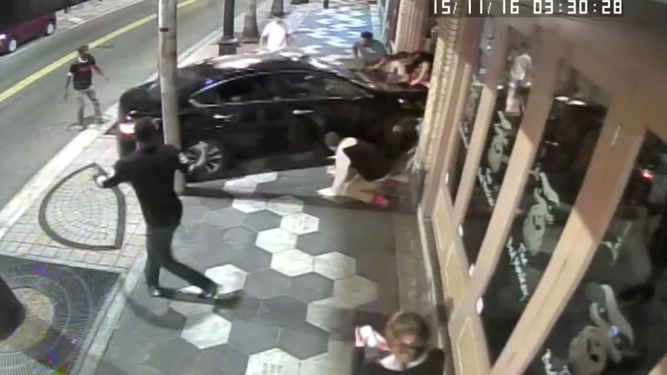  The vehicle hits two of the men and smashes into the entrance of a bar