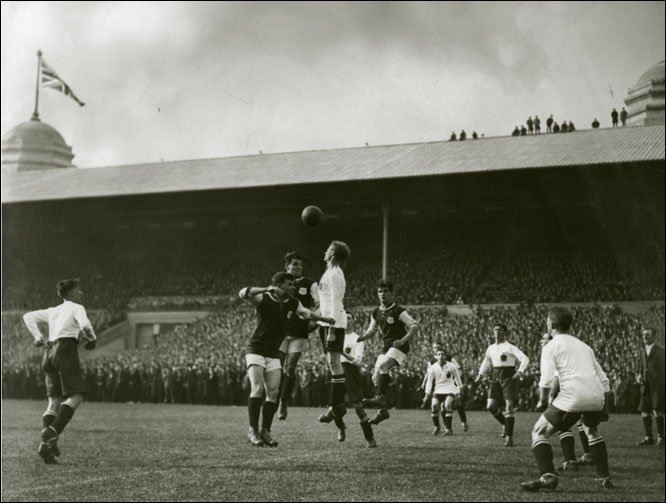  The Cup Final gets under way. Crowds were crammed along the touchline and some daring spectators watched from the stadium's rooftops.