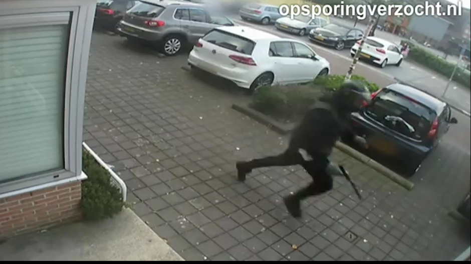  When the innocent man realises something is wrong and runs away, one of the men gets off the scooter and chases after him, firing shots after him