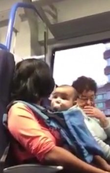  The mum takes her seat on the train with her baby son