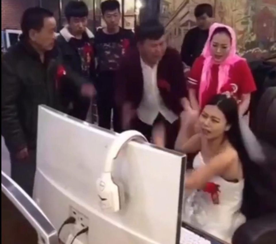  The bride is determined to finish her game despite the groom's protests