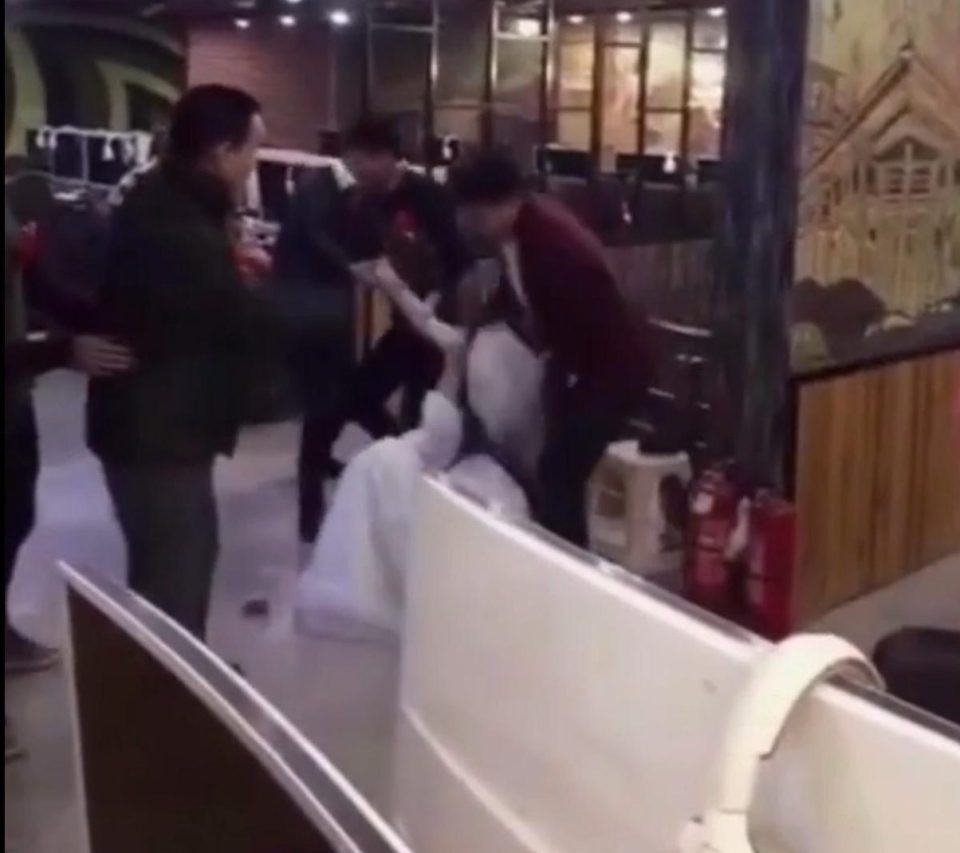  The gaming-addict bride is filmed being dragged away by the wedding party