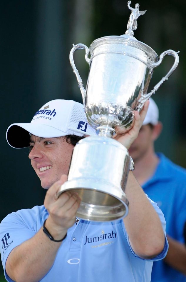  Victorious McIlroy holds the US Open trophy aloft