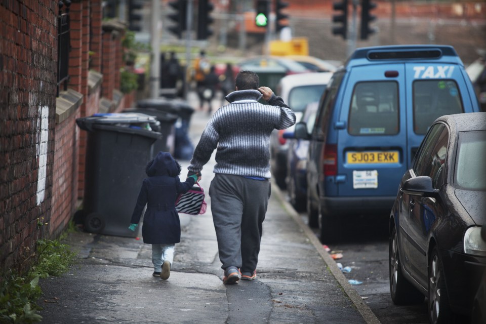  A Roma man walks his daughter to school in the streets of Sheffield