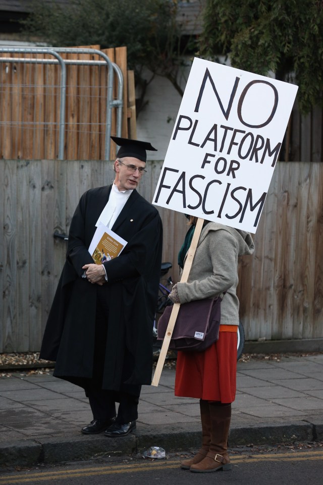  A Cambridge Proctor speaks to a protester ... NUS has itself been found to have serious failings when it comes to racism