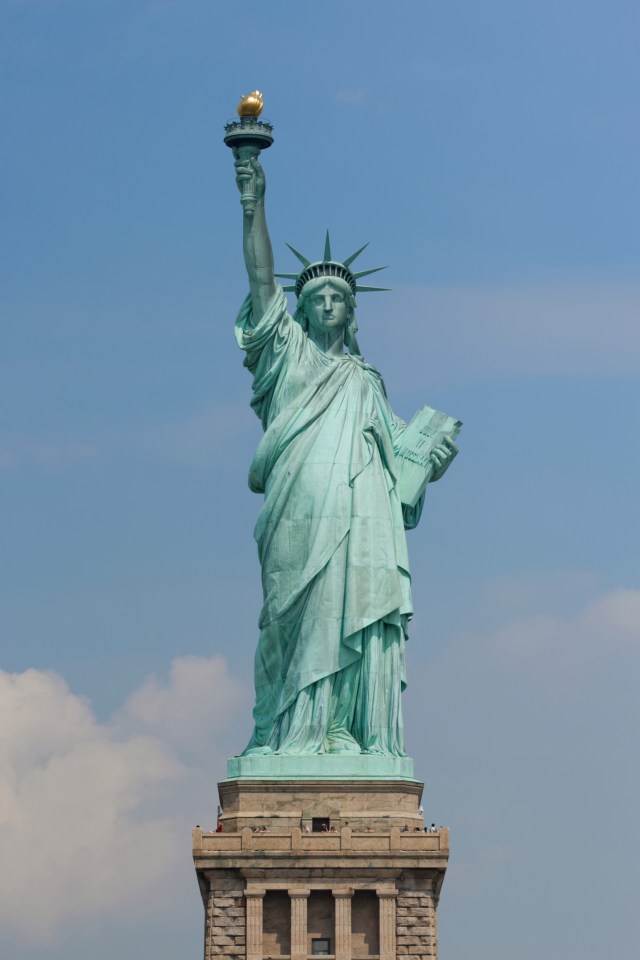  The Statue of Liberty stands over New York in America