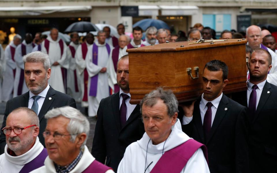  The coffin of Father Hamel is carried outside the Rouen cathedral, Normandy, before his funeral mass