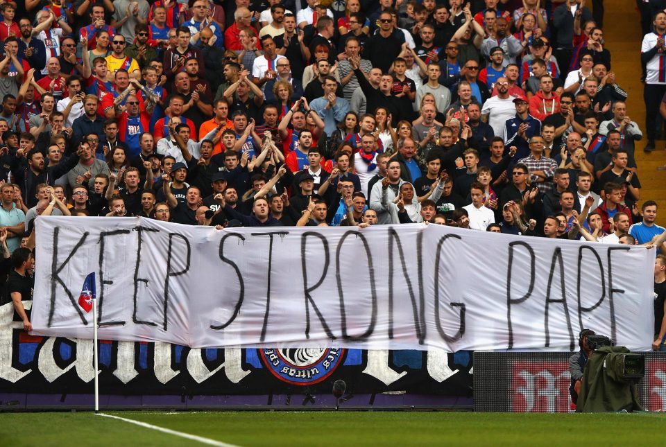 Crystal Palace supporters hold up a touching tribute to injury-stricken star Pape Souare