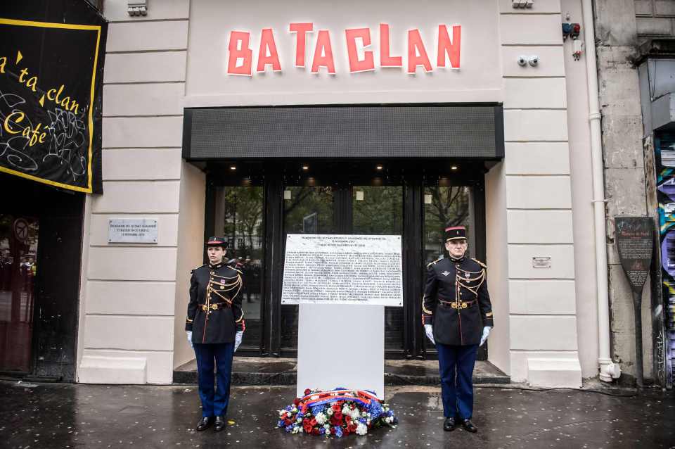 French guards tand next to a commemorative plaque at the Bataclan concert hall in Paris after a ceremony marking the first anniversary of the Paris terror attacks