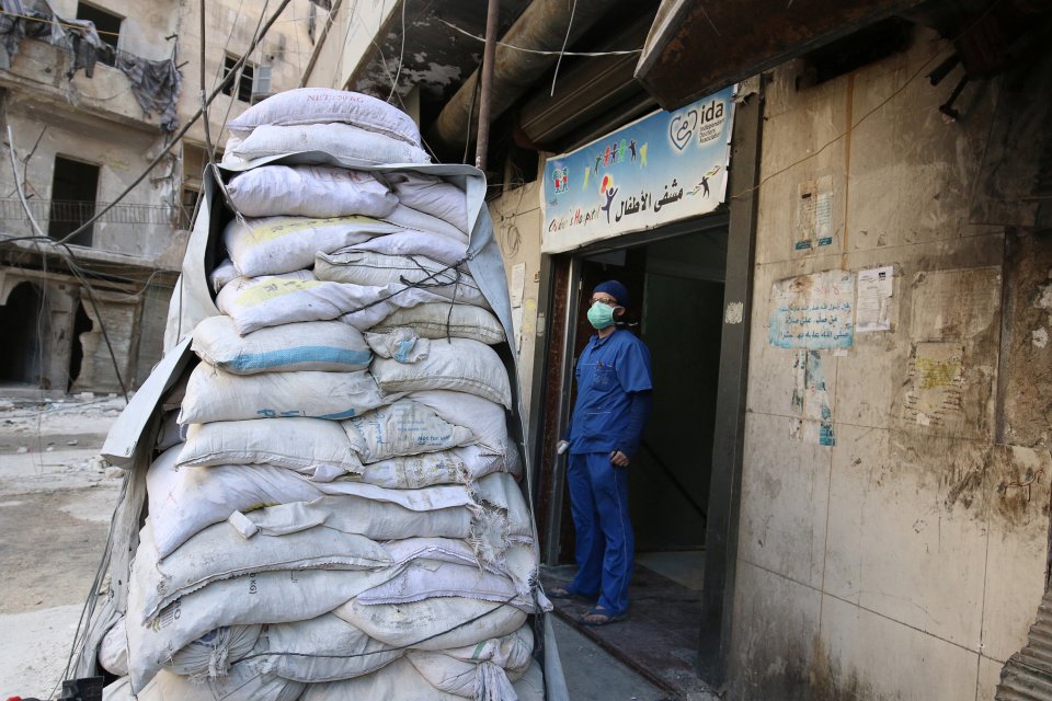  A medic stands behind sandbags in the damaged al-Hakeem hospital in rebel-held Aleppo last month