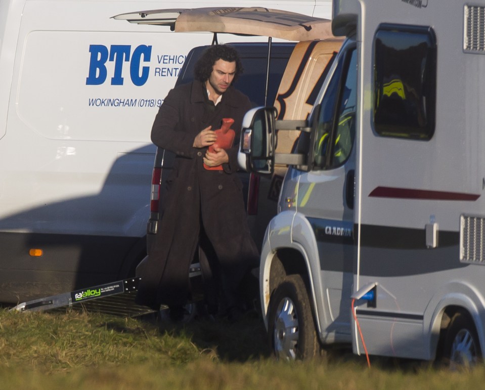  Aiden Turner clutches a hot water bottle on a bitterly cold set of Poldark near Cirencester