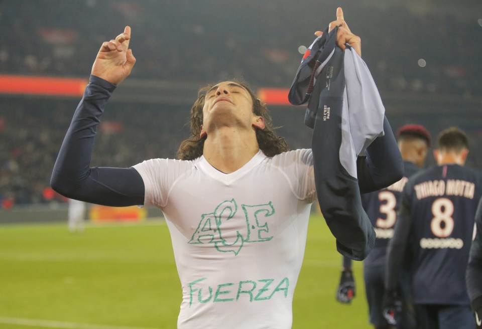  PSG's Edinson Cavani celebrates his penalty by showing the logo of Chapecoense