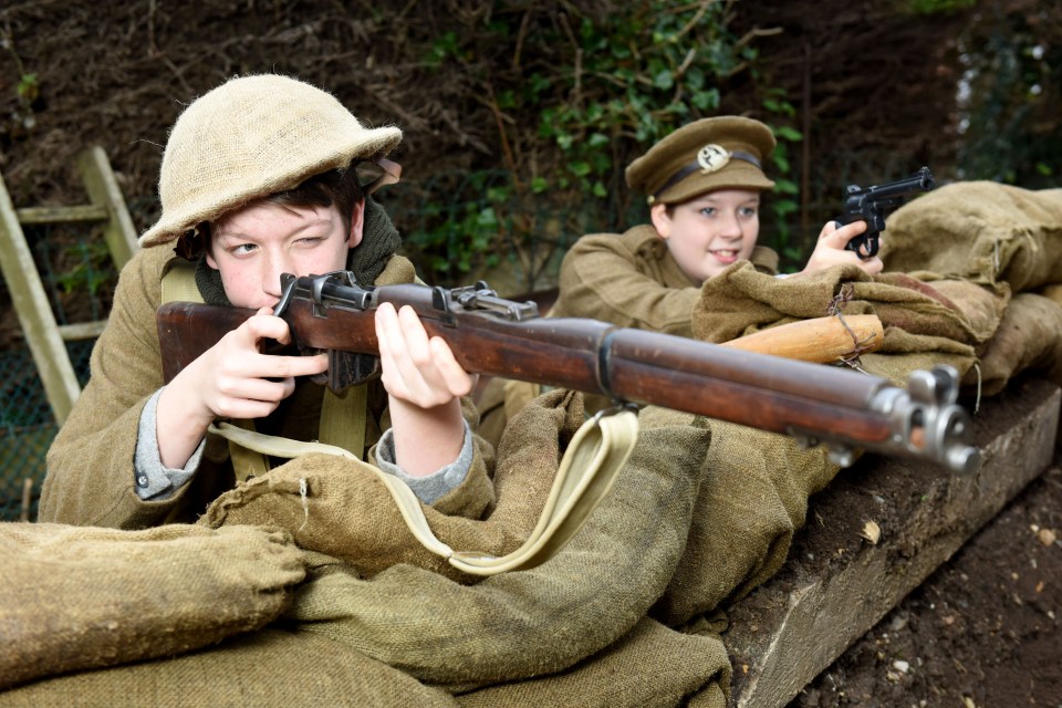  Ethan, left, and Reuben, right, have the mock firearms and uniforms to match their battle scene