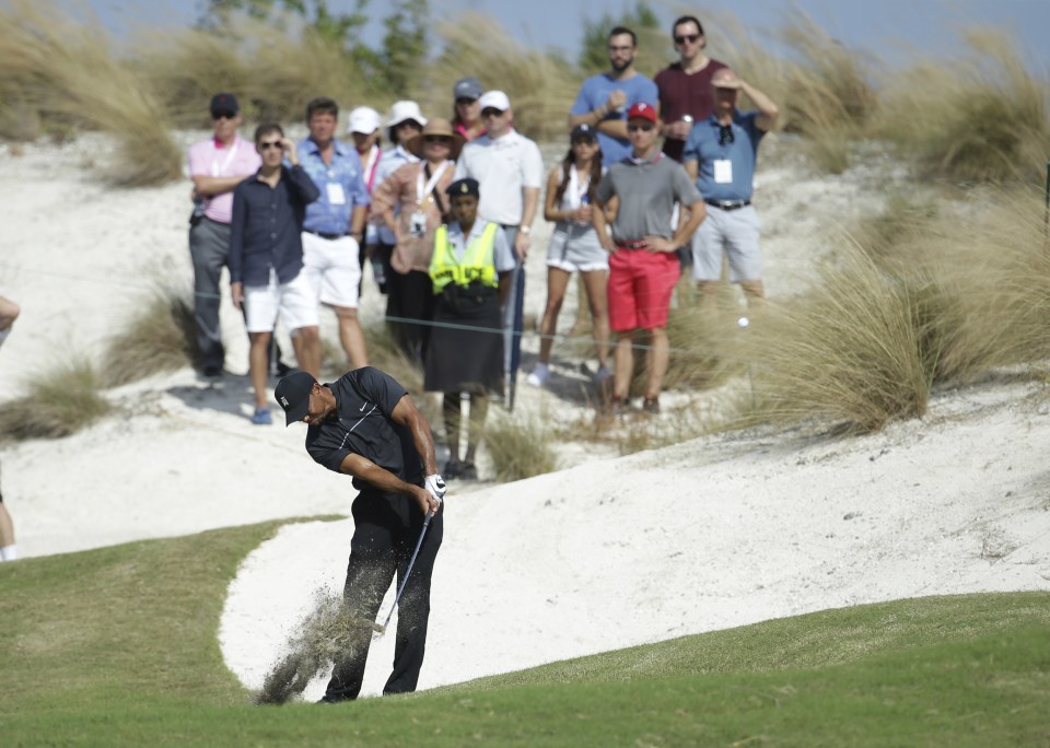 Tiger Woods hits from the first fairway