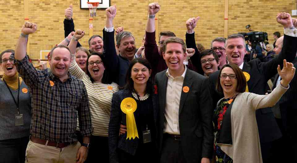  Ms Olney celebrates with her husband Ben and party supporters after winning her seat