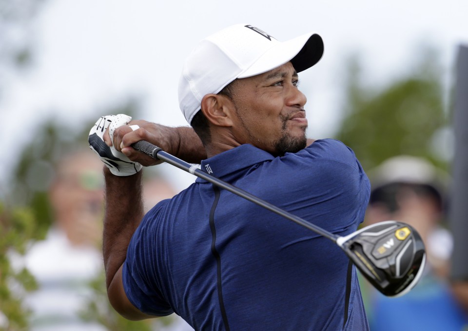 Tiger Woods watches his tee shot on the first hole during the second round at the Hero World Challenge golf tournament