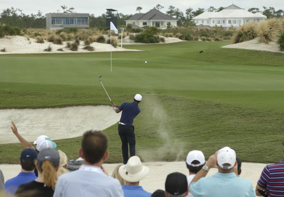 Tiger Wood hits onto the 6th green during the second round at the Hero World Challenge golf tournament, Friday, Dec. 2, 2016, in Nassau, Bahamas