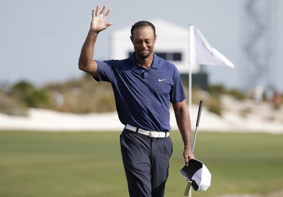 Tiger Woods waves as he walks off the 18th hole during the second round at the Hero World Challenge golf tournament, Friday, Dec. 2, 2016, in Nassau, Bahamas