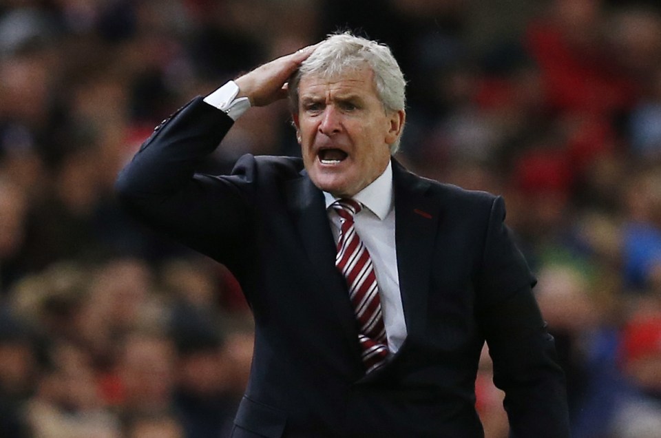  Stoke City manager Mark Hughes gestures towards his players