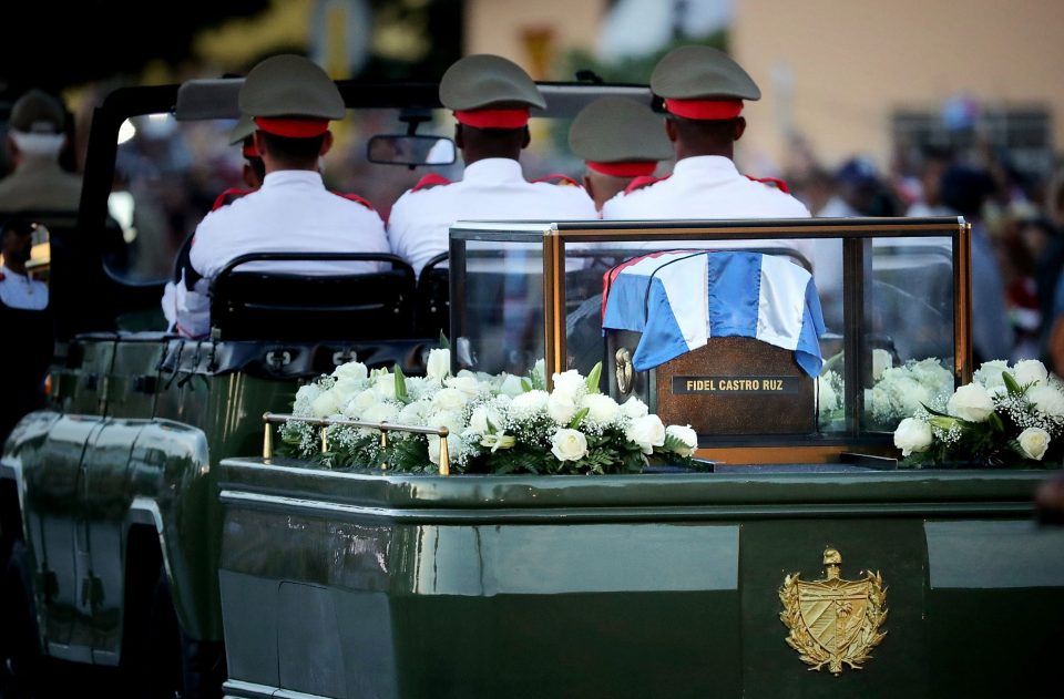  The convoy was flanked by thousands of mourners