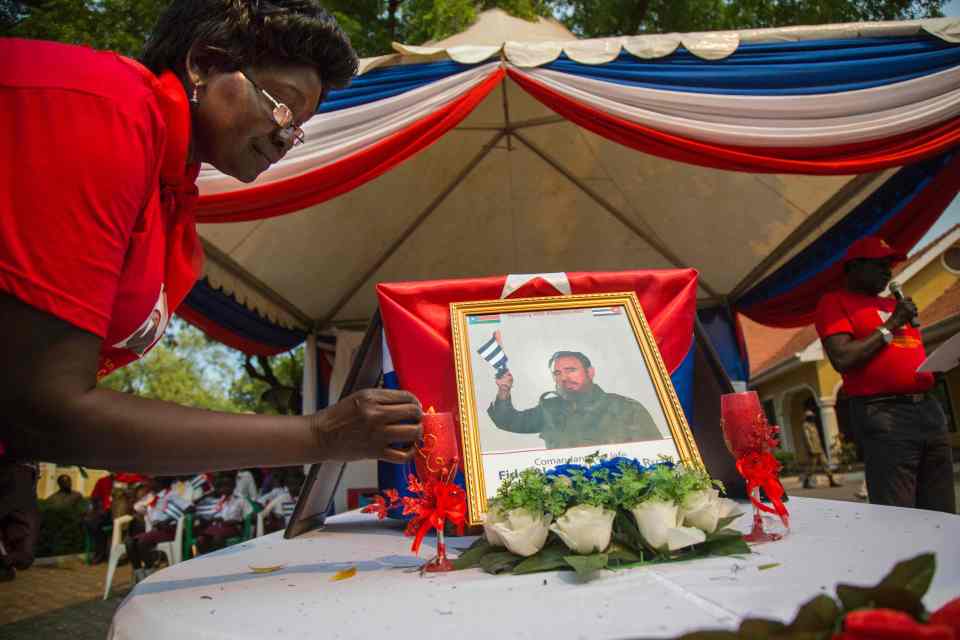  A former South Sudanese refugee in Cuba lights a candle at the memorial service