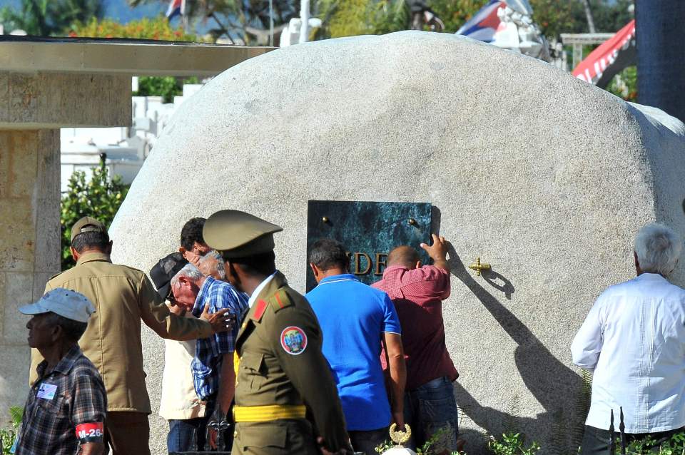  Workers fix the plaque with his name on Cuban leader Fidel Castro's tomb at the Santa Ifigenia cemetery Santiago de Cub